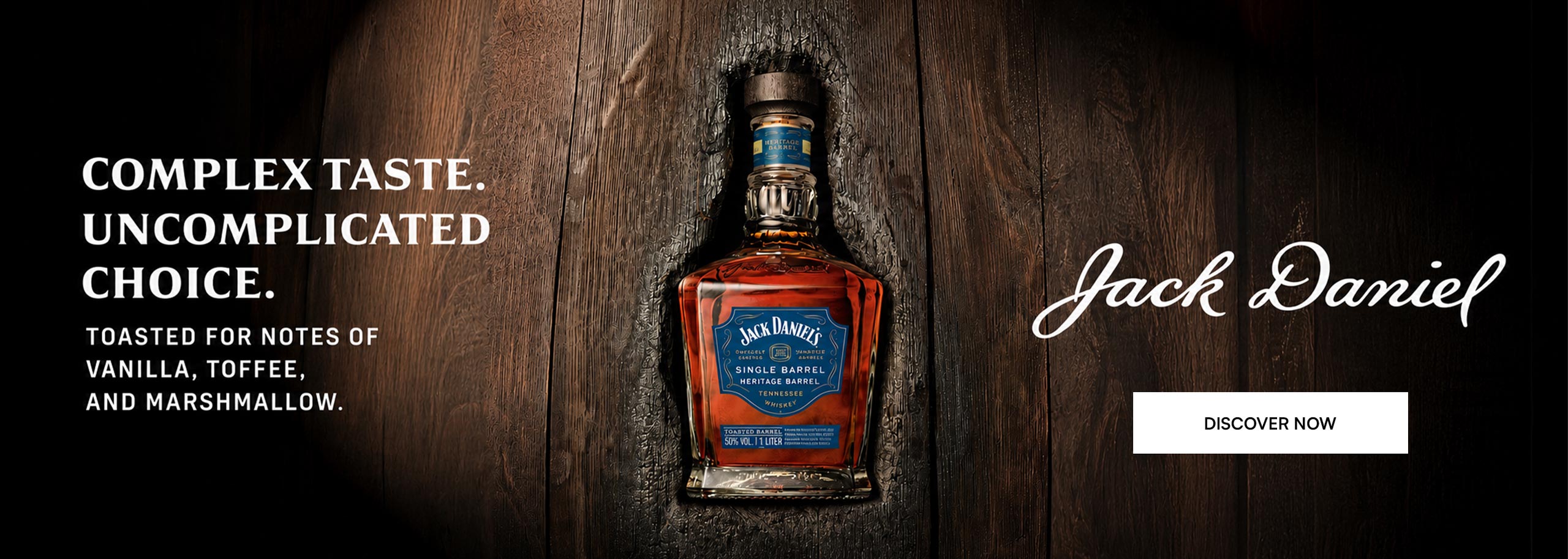 A bottle of Jack Daniel's Single Barrel Heritage on a wooden background.