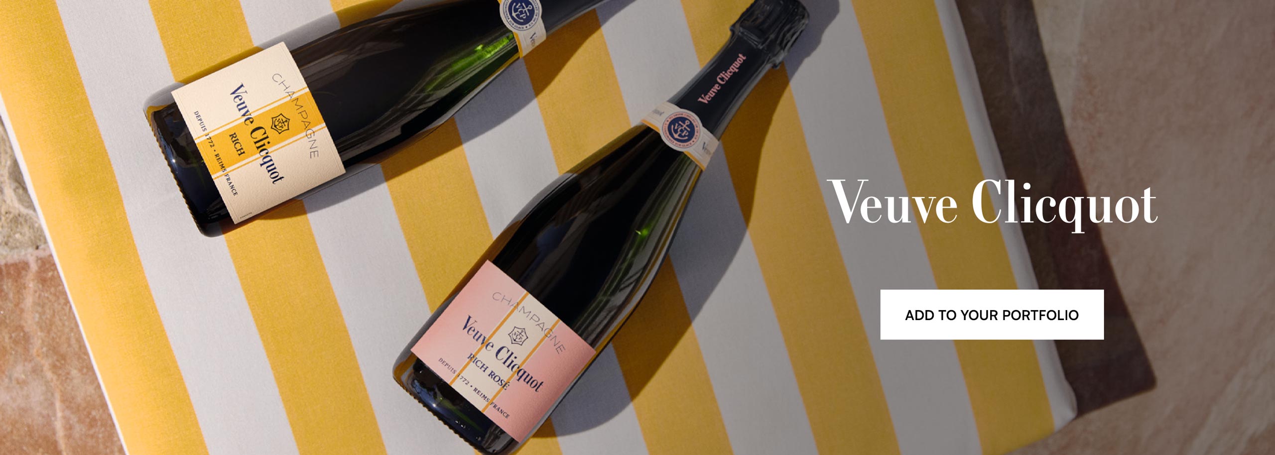 A bottle of Veuve Clicquot Rich and a bottle of Veuve Clicquot Rich Rosé against a white and yellow striped background.