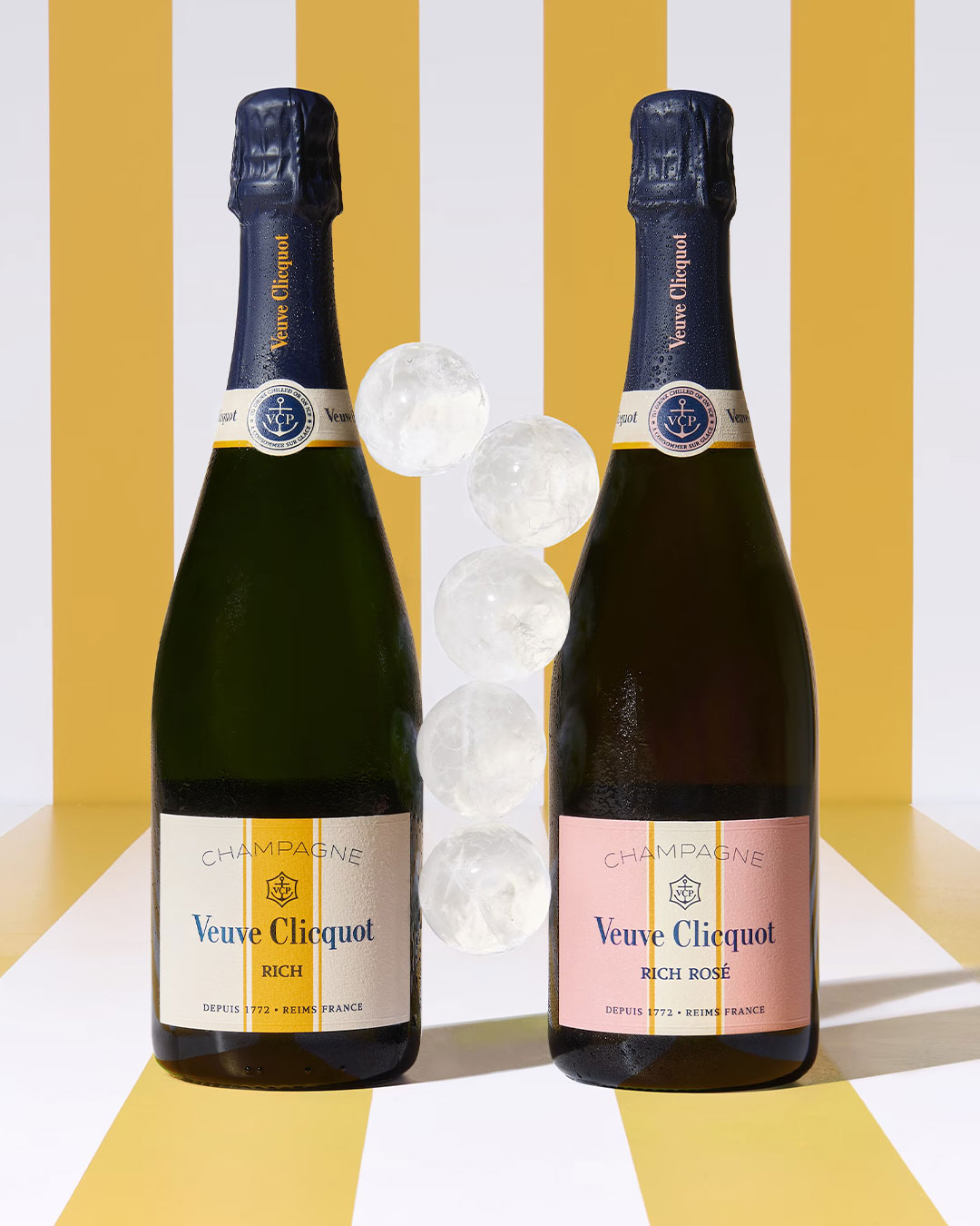 A bottle of Veuve Clicquot Rich and a bottle of Veuve Clicquot Rich Rosé against a white and yellow striped background.