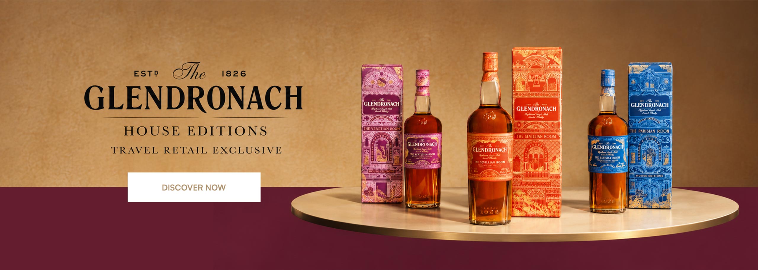 Three bottles of whisky The Glendronach with boxes on a table.